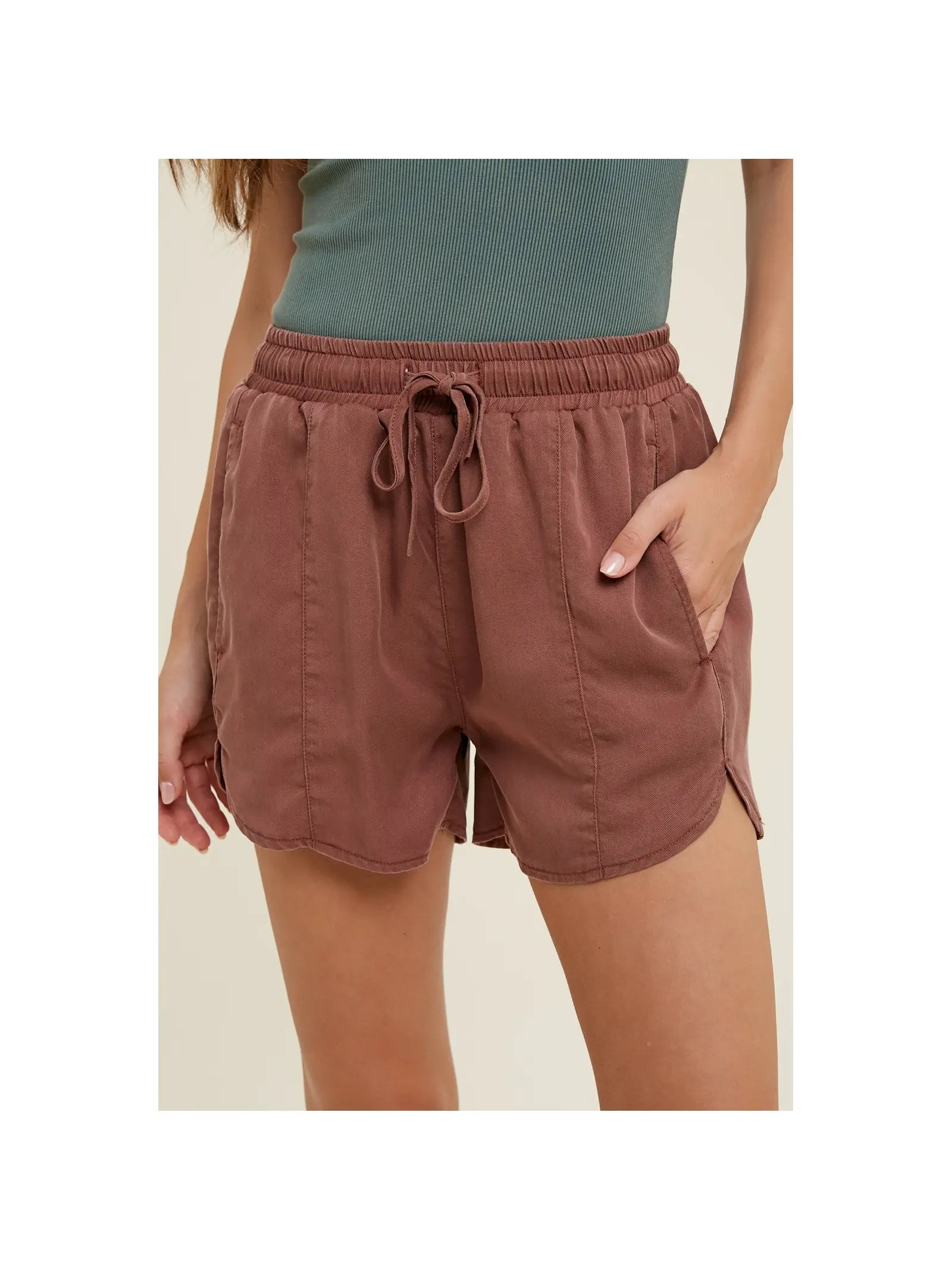 Front view of light weight, flowy shorts with a drawstring, elastic waistband and dolphin hem 
