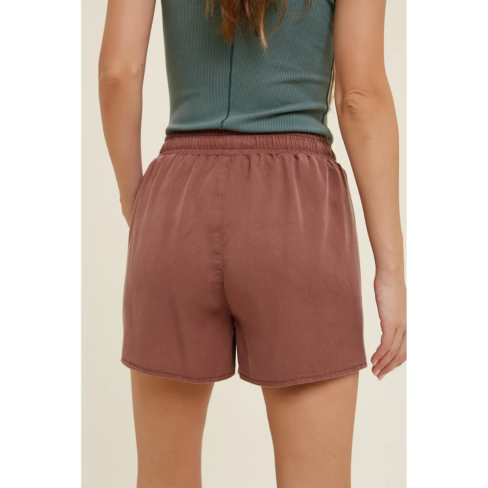 back view of light weight, flowy shorts with a drawstring, elastic waistband and dolphin hem 