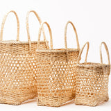 Three straw baskets aligned next to each other on a white background