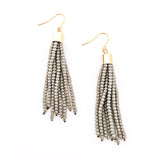 Pair of beaded tassel earrings in grey color with gold caps and hooks over solid white background