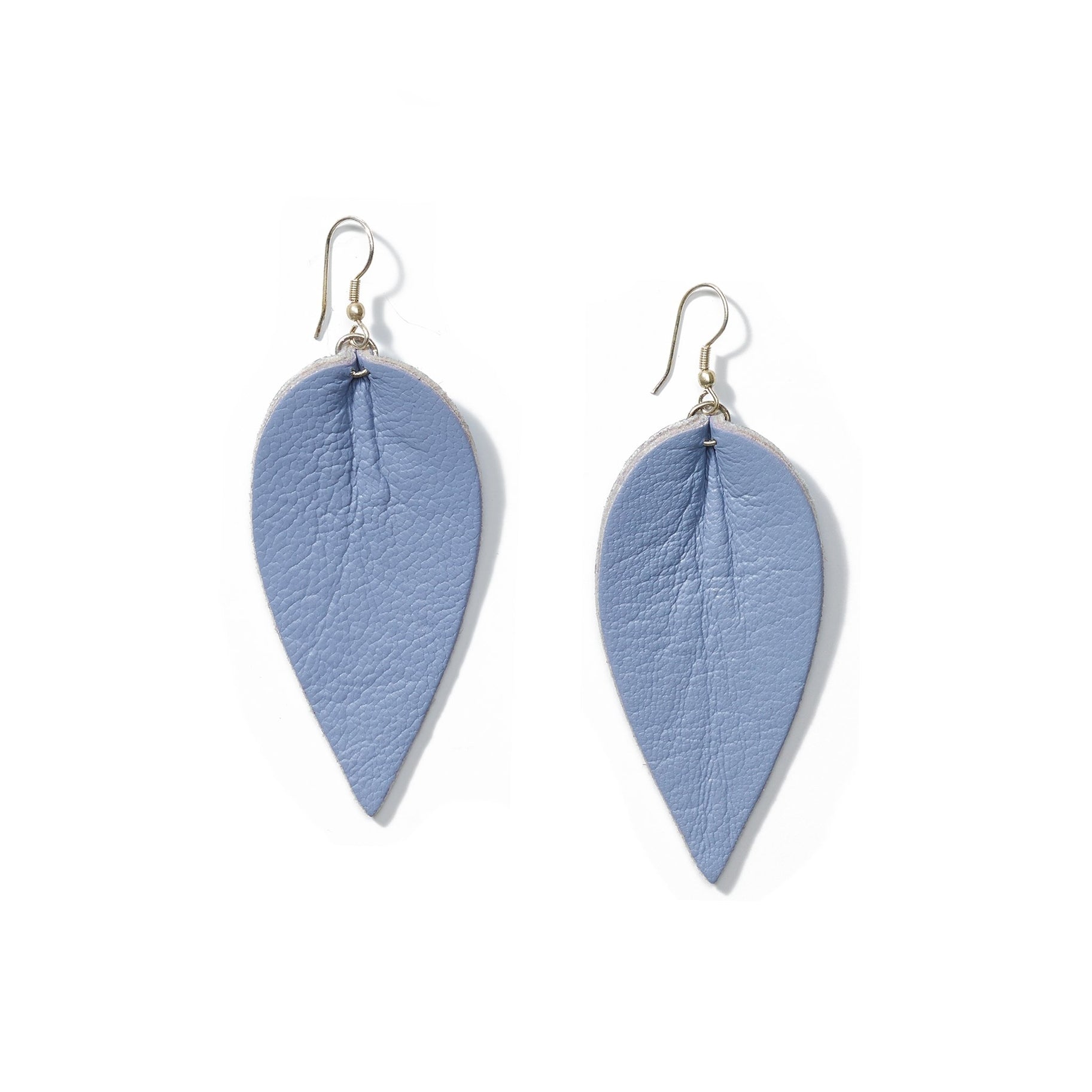 Pair of blue leather earrings in the shape of an upside-down teardrop in front of a solid white backdrop
