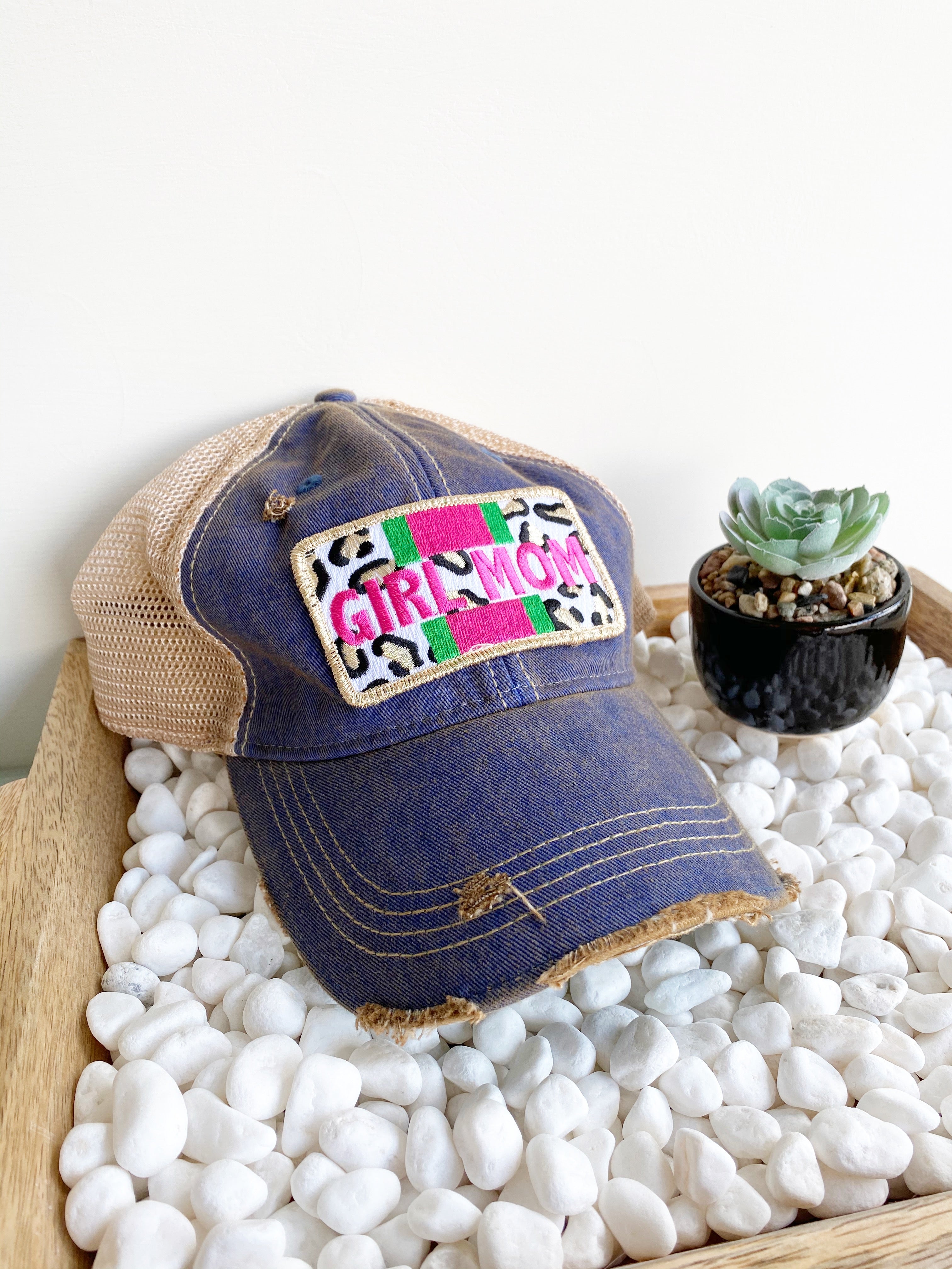 Distressed denim and mesh hat that reads GIRL MOM with leopard print, green, and pink embroidery
