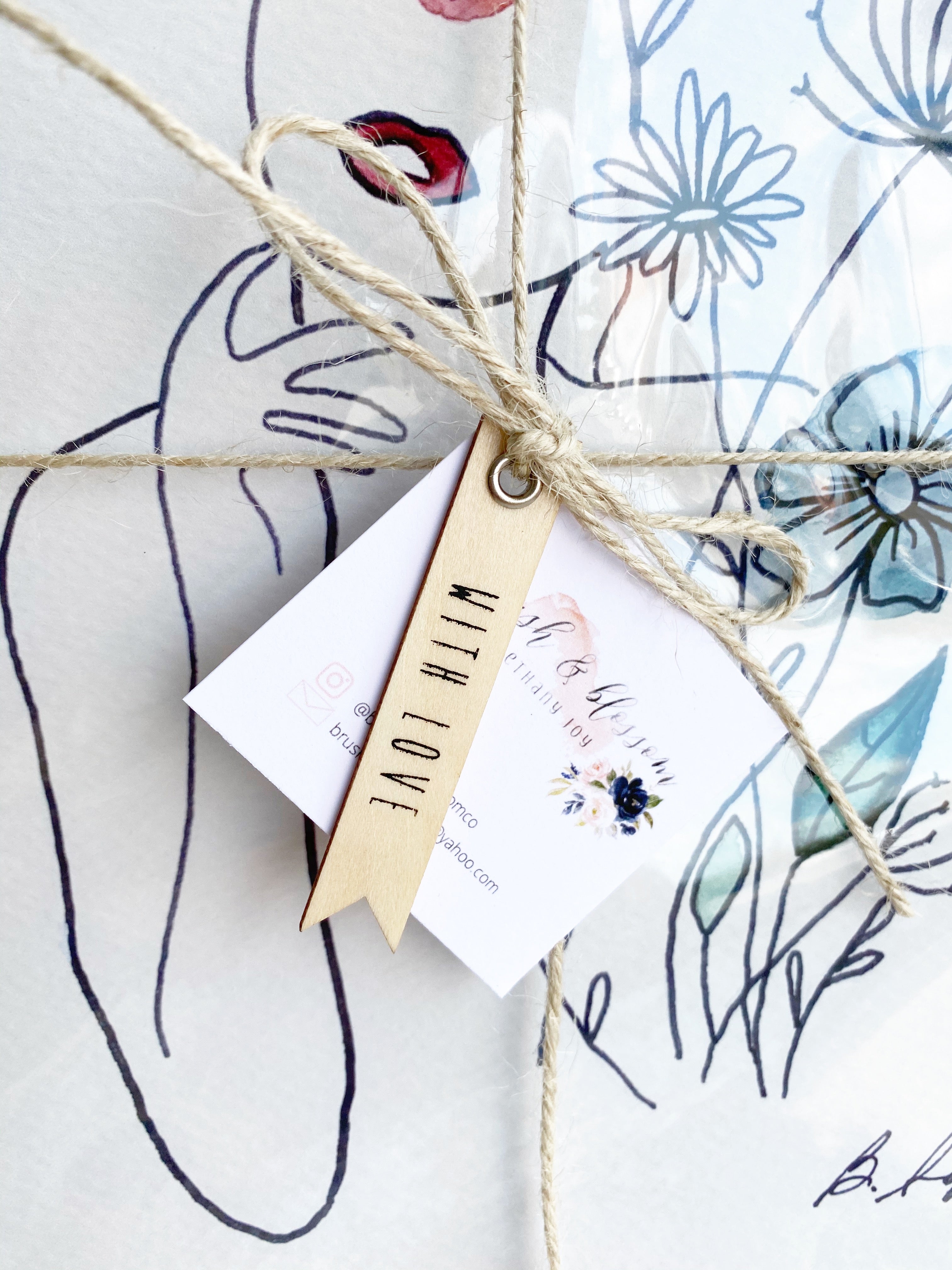 Close up of artwork print tag tied on with twine and a wooden with love tag