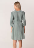 Mini dress, 3/4 length sleeve, lace detail, hidden buttons, and tie waste in sea green. Back View